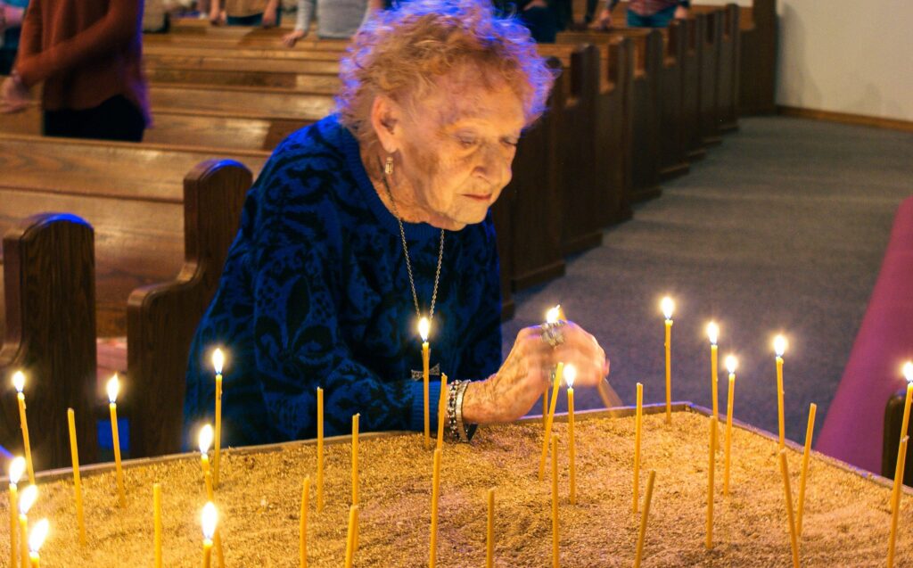 woman lighting candle at Waypoint